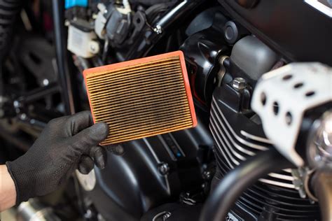Mecánico instalando un filtro de aire en una motocicleta